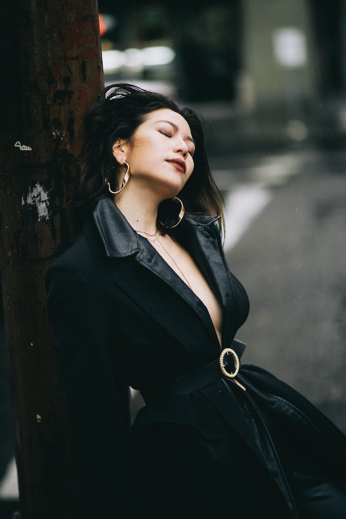 Elegant woman standing near pillar on street